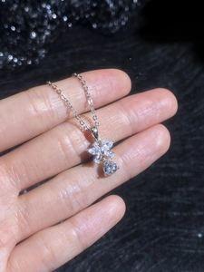 Macro shot of butterfly wing pendant with marquise-cut stones on a silver chain