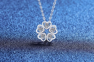 Macro detail of S925 silver five-petal flower pendant with heart-shaped moissanite stones