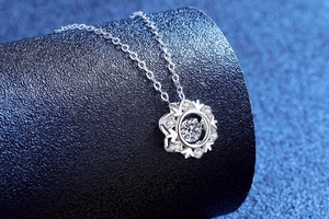 Close-up of S925 sterling silver snowflake pendant with dancing moissanite stone