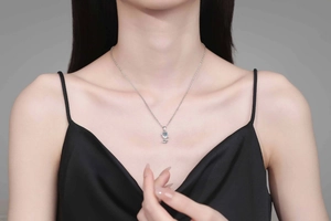 Detail of s925 silver tulip necklace with blue moissanite gemstone on model