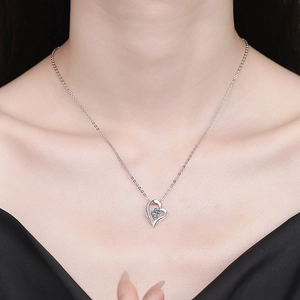 Moissanite S925 sterling silver heart pendant necklace shown worn on a model's neck