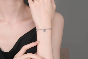 Detailed view of an S925 sterling silver bracelet featuring a round moissanite charm