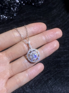 Macro shot of silver S925 compass pendant necklace with sparkling Moissanite stones