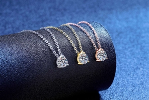 Close-up of sparkling moissanite necklaces in silver, gold, and rose gold plating