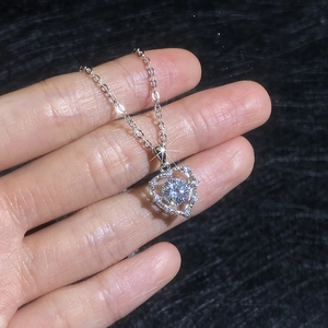 Sparkling S925 silver heart necklace featuring a dancing moissanite stone in center