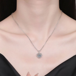 S925 sterling silver heart necklace with sparkling center stone worn by a female model
