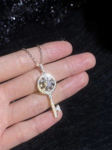 Détail macro du pendentif clé fleur de soleil en argent s925 avec moissanite étincelante