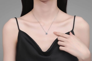Close-up of minimalist S925 sterling silver necklace with a round brilliant moissanite stone