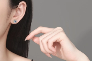 Detailed close-up of 925 silver moissanite stud earring worn on a model ear
