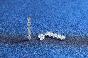 Macro shot of S925 sterling silver drop earrings with five sparkling moissanite stones