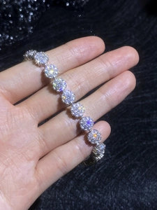 Detailed view of silver moissanite sunflower bracelet with micro-pave cluster design