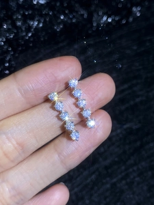 Macro shot of S925 sterling silver drop earrings with five graduated moissanite stones