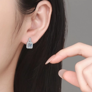 Luxury S925 sterling silver princess cut moissanite stud earrings on a model