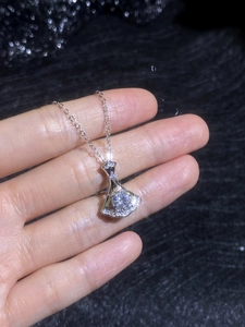Detailed macro view of 1ct moissanite fan pendant necklace with sparkling skirt design