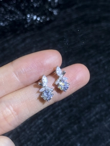 Macro shot of S925 sterling silver bow earrings with sparkling marquise moissanite stones