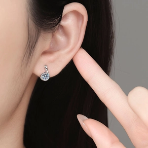 Elegant s925 silver moissanite stud earrings with a spiral design shown on a model