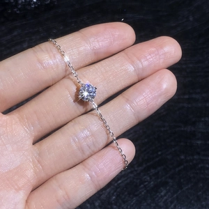 Elegant adjustable four-prong moissanite bracelet with a brilliant round cut stone
