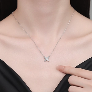 Elegant s925 silver X-shaped pendant necklace with sparkling stones on a model