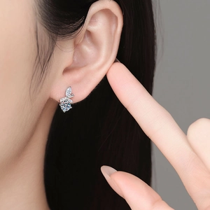 Elegant S925 silver moissanite stud earrings featuring leaf-shaped accents on model