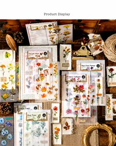 Detailed view of vintage flower stickers with rose and sunflower patterns for scrapbooking