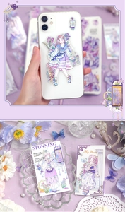 Close-up of dreamy purple anime girl PET stickers on phone and vintage lace decor