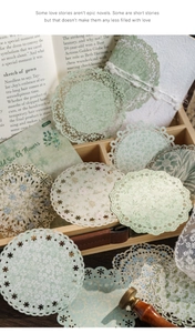 Detail of vintage floral lace paper doilies for journaling with intricate cutouts