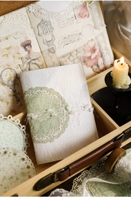 Detailed view of vintage lace paper used for scrapbook decoration inside a wooden box