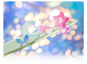 Close-up of glitter laser stickers featuring stars and butterflies with starlight film