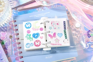Close-up of a 3-ring binder notebook featuring glittery butterfly and star stickers