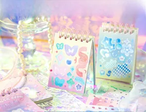 Detailed close-up of decorative sticker book with laser holographic butterfly and ribbon patterns