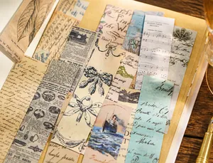 Detail of vintage scrapbooking stickers with old newspapers and musical notes on a desk