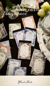 Detail of vintage scrapbooking paper with floral patterns and retro frames on table
