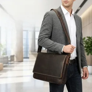 Vertical genuine leather messenger bag shown with wide shoulder strap and flap closure