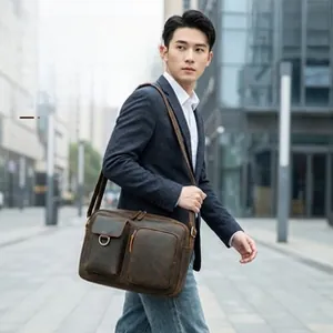 Vertical genuine cowhide crossbody bag worn by a man in a formal business suit