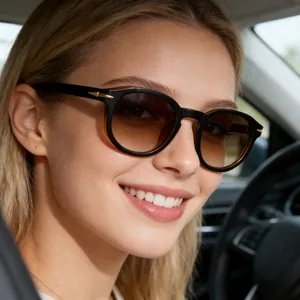 Detail of round sunglasses with black frames, brown gradient lenses and gold arrow hinges
