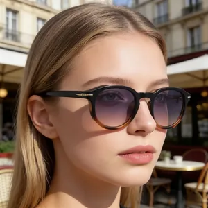 Detail of round gradient purple lenses with black and tortoiseshell frames and gold accents
