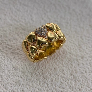 Detail of vintage 18k gold plated double layered heart ring with pavé diamond accents