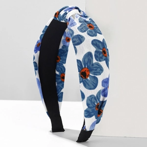 Floral print twisted headband with blue and orange flower patterns on fabric