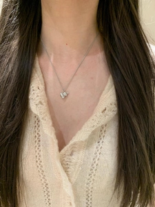 Close-up of S925 sterling silver gourd necklace on a model wearing beige cardigan