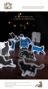 Detailed close-up of cat silhouette paper stickers and furniture cutouts on dark wood grain