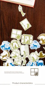 Close-up of cat and window themed stickers with die-cut edges on a wooden background