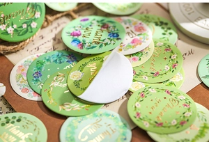 Detail of floral round stickers with gold foil Thank You text and botanical border