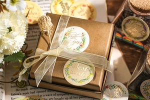 Detail of floral gratitude stickers with gold foil and Best Wish text on gift box