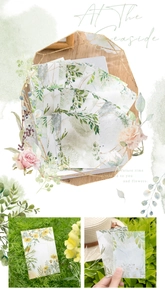 Close-up of floral watercolor stickers and botanical memo pads for junk journaling