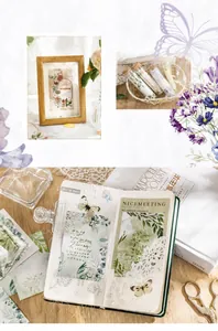 Detailed close-up of vintage floral and butterfly stickers for DIY scrapbooking journaling