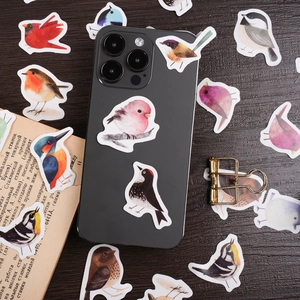 Watercolor bird stickers set for journals including robins and tits on wooden background