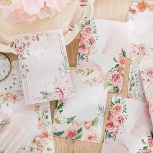 Watercolor vintage floral memo pad set with rose patterns on a wooden desk background