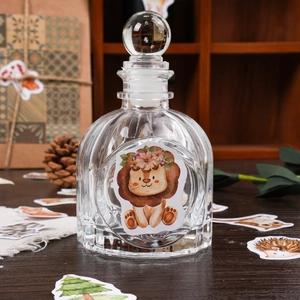 DIY jungle animal stickers featuring a cartoon lion on a vintage ribbed glass bottle
