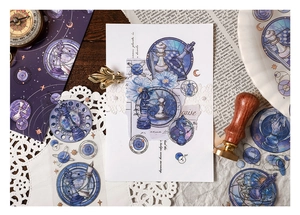 Detailed flat lay of celestial PET stickers featuring chess and galaxy patterns for journaling