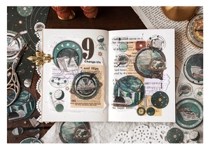 Artistic detail of vintage celestial PET stickers with globes and star maps on a journal